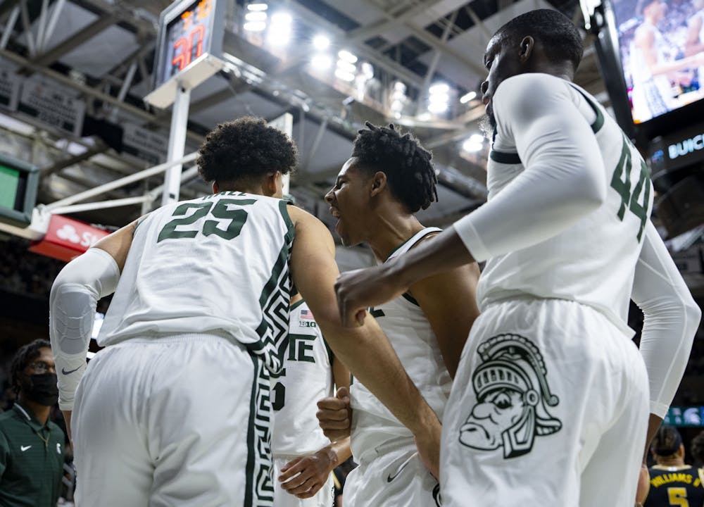 <p>Sophomore guard A.J. Hoggard (11) cheers with junior forward Malik Hall (25) after a successful rebound during MSU’s game against the University of Michigan on Saturday, Jan. 29, 2022. The Spartans ultimately beat the Wolverines 83-67.</p>