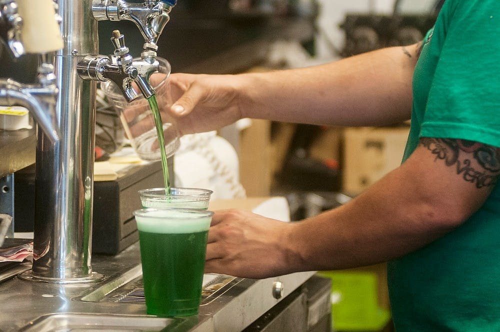 	<p>Lansing resident and general manager of What Up Dawg? Bill Schramm pours a pint Oct. 8, 2013, at What Up Dawg? on 317 M.A.C. Avenue. Schramm thinks that it is ignorant to create a law demanding that a pint be exactly 16 oz. He says obviously he does not want customers to get ripped off, but thinks businesses should be trustworthy in the first place. Margaux Forster/The State News</p>