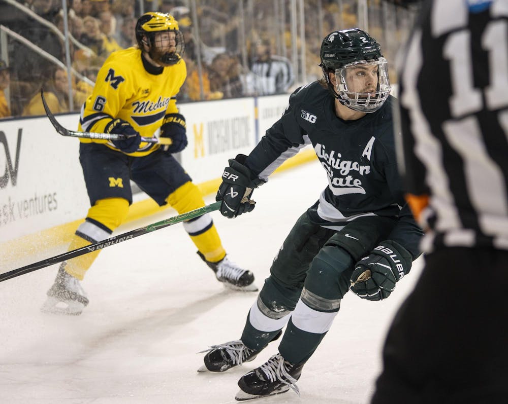 <p>Michigan State junior defense Patrick Geary (2) and University of Michigan senior forward Josh Eernisse (6)skate after the puck at the Yost Ice Arena in Ann Arbor, Mich. on Dec. 6, 2025.</p>