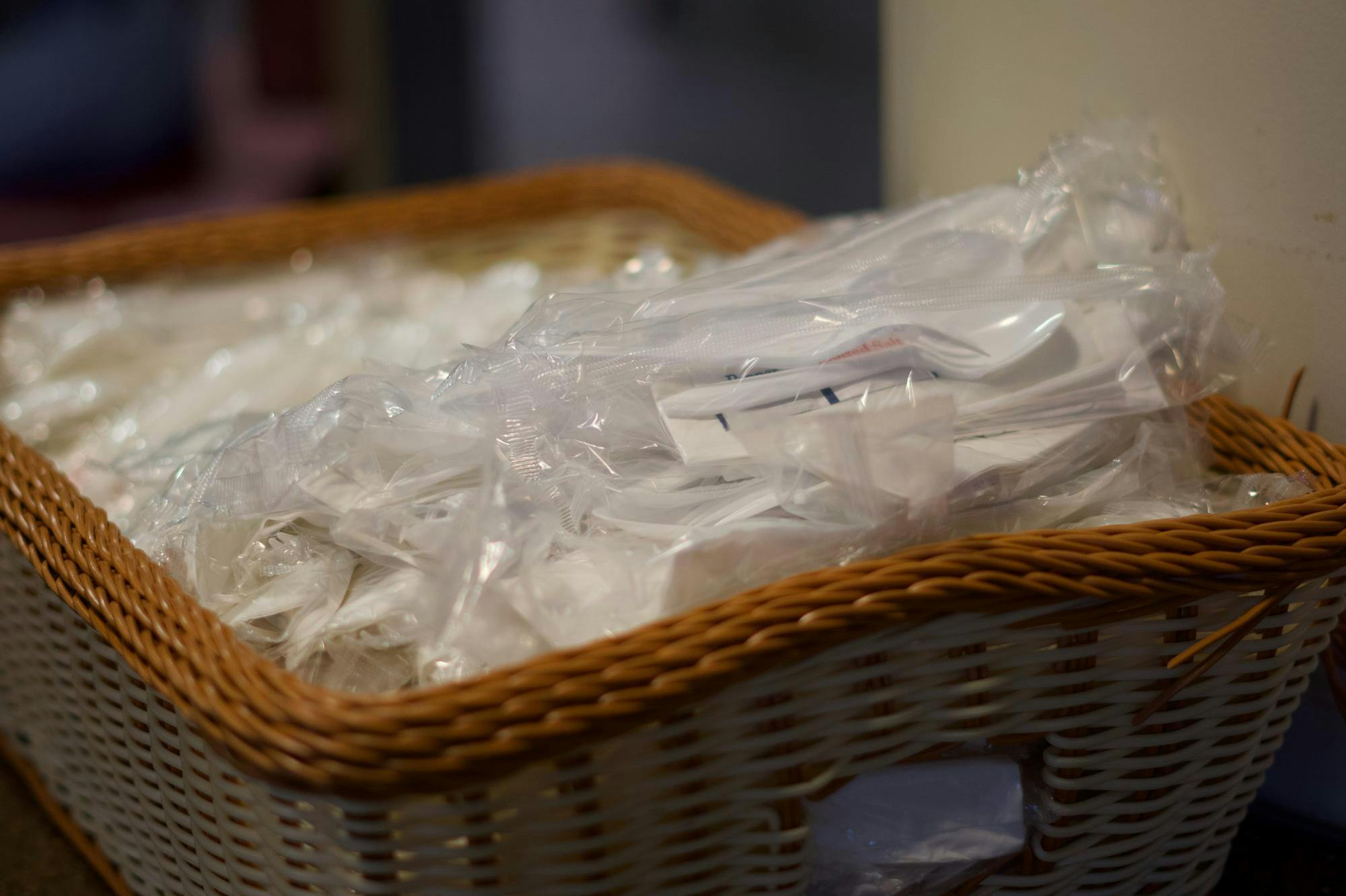 <p>Basket of plastic cutlery at The Gallery at Snyder-Phillips dining hall is stocked for the dinner rush on Sept. 6, 2023. Students picked up these packets on their way into the dining hall before lining up to get food.</p>