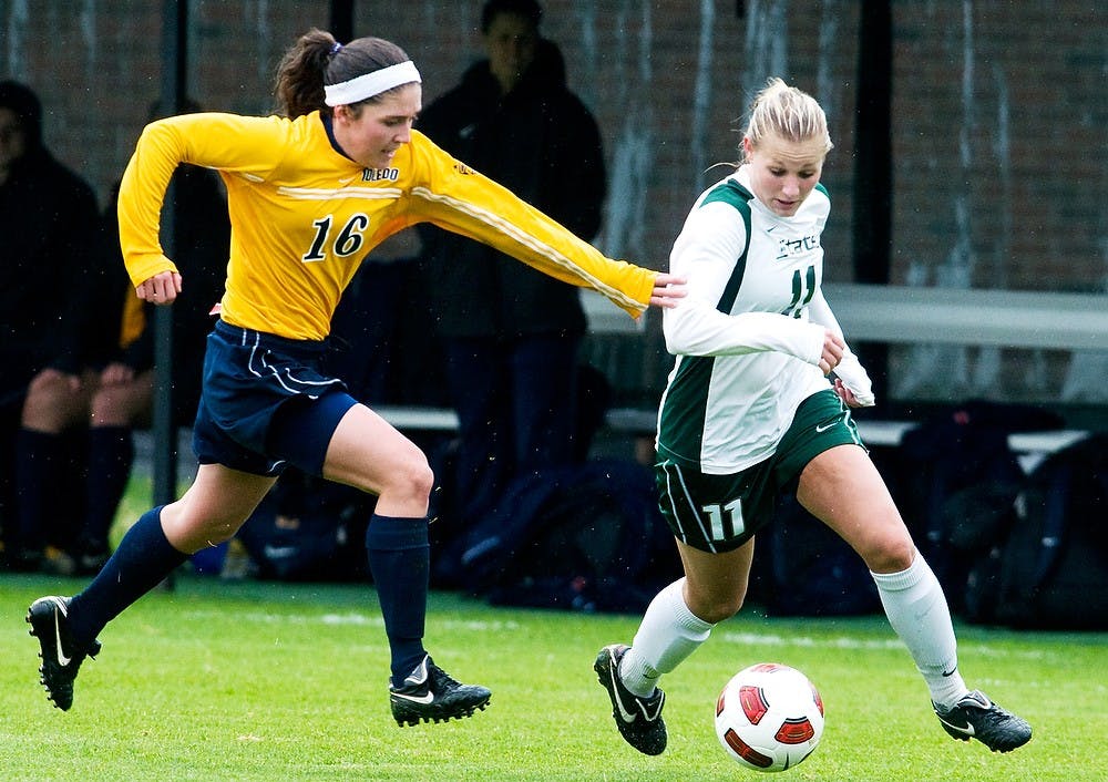 Then-junior forward Laura Heyboer sprints up field as Toledo defender Natalia Gait?n attempts to catch up on April 16, 2011 at DeMartin Stadium at Old College Field. The exhibition match resulted in a 1-1 tie. Matt Hallowell/The State News