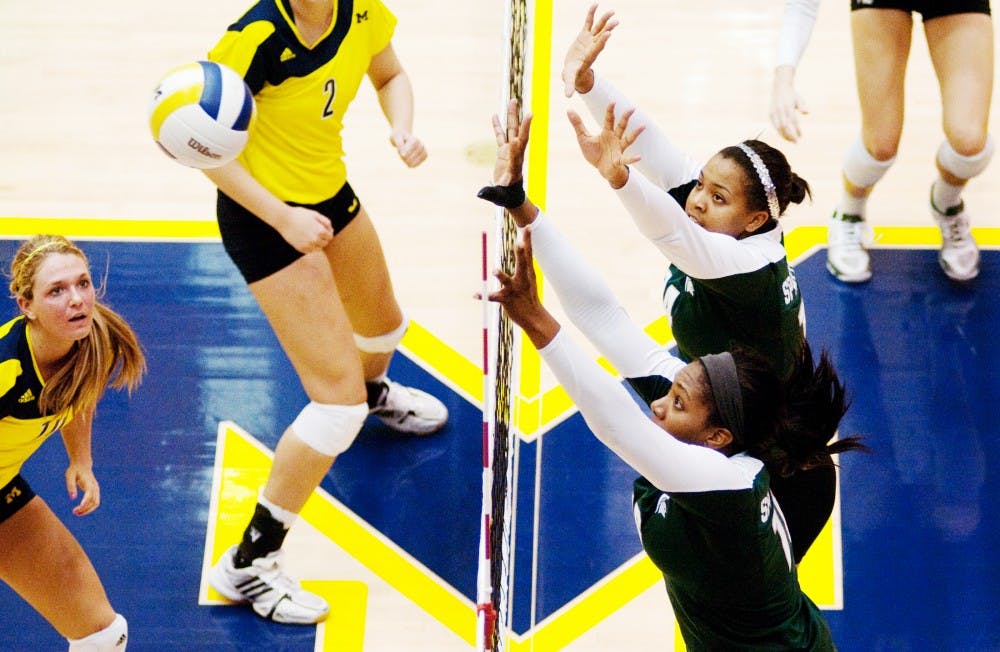 Senior outside hitter Kyndra Abron and freshman middle blocker Jazmine White go up to block a spike against U-M. The Spartans lost to the Wolverines, 3-1, on Wednesday evening at Cliff Kreen Arena in Ann Arbor. Josh Radtke/The State News