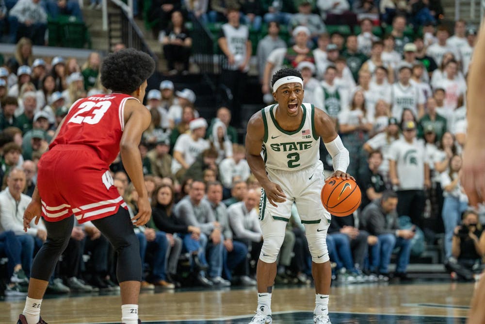 MSU Graduate Student Guard Tyson Walker (2) directs a play during their game matchup against Wisconsin at the Breslin Center on Dec. 5, 2023. MSU would go on to lose 57-70 against 23 Wisconsin.