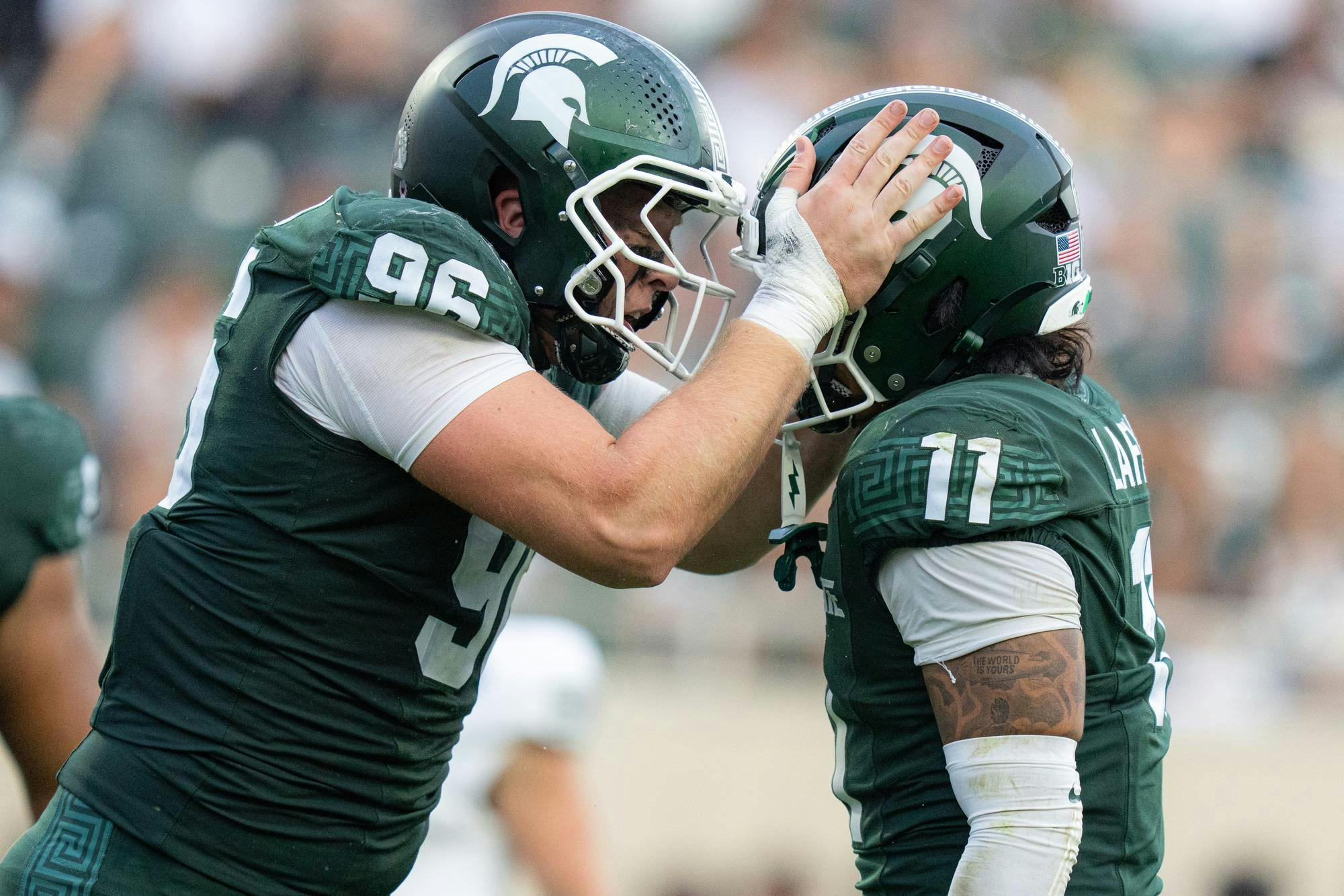 <p>Michigan State defensive lineman Eli Coenen (96) gives a pep talk to Michigan State edge Anelu Lafaele (11) at Spartan Stadium in East Lansing, Mich., on Sept. 12, 2026.</p>