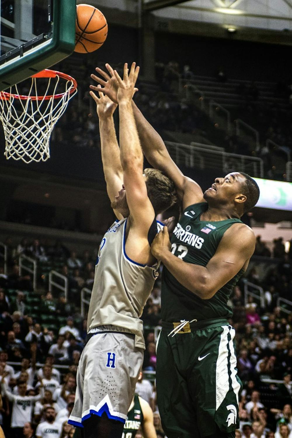 Sophomore forward Nick Ward attempts to black Hillsdale forward Trenton Richardson (32) during the game against Hillsdale on Nov. 3, 2017 at the Breslin Center.The Spartans defeated the Chargers, 75-44.