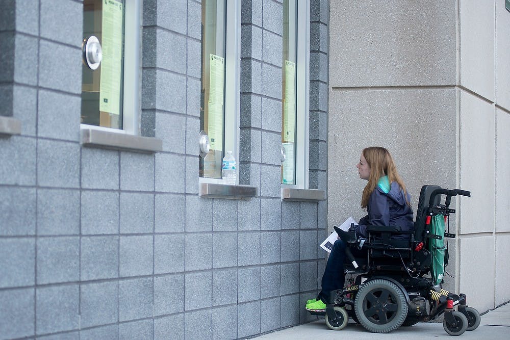 <p>Advertising junior Katie Feirer exchanges her tickets for a handicap seat before the game against Wyoming on Sept. 27, 2014, at Spartan Stadium. Feirer gets to the stadium hours early to ensure she gets a handicap seat, as there are limited spots. Julia Nagy/The State News</p>