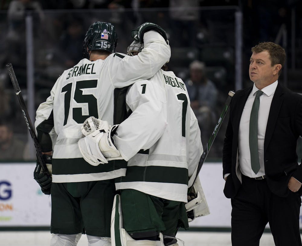  Michigan State University men’s hockey head coach Adam Nightingale walks out onto the ice while the players celebrate their 4-3 win against Notre Dame on Nov. 16, 2024. 