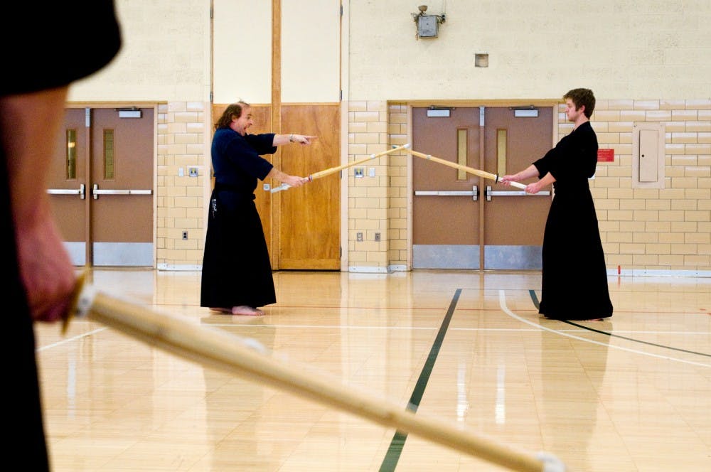 Kendo instructor Ron Fox, left, demonstrates technique with his teaching assistant Jordan Holmgren Monday at IM Sports-Circle. Kendo is just one of many activities students can use to stay healthy during American Heart Month, which runs through February. Matt Radick/The State News