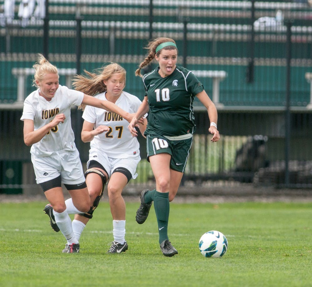 	<p>Junior defender Annie Steinlage kicks the ball down the field with Iowa defender Alex Melin, No. 19, and midfielder Katie Nasenbenny behind her. The Spartans tied with the Hawkeyes, 0-0, on Sunday, Sept. 30, 2012 at DeMartin Stadium. Justin Wan/The State News</p>