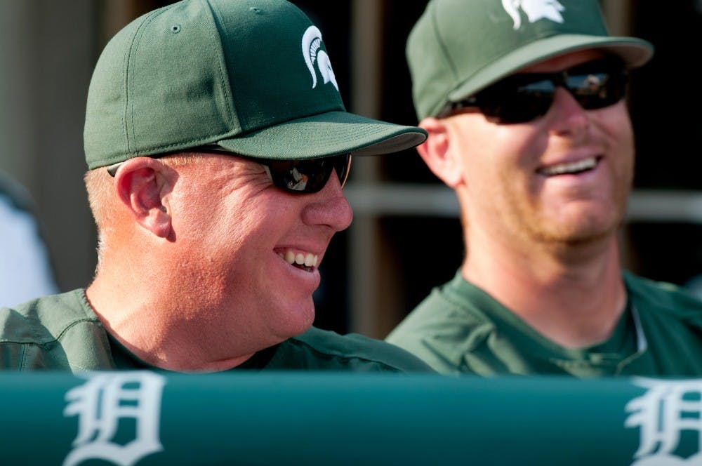 Head coach Jake Boss Jr. smiles while standing in the dugout Tuesday evening when Michigan State faced Central Michigan at Comerica Park in Detroit. The Spartans beat the Chippewas 5-2. Samantha Radecki/The State News