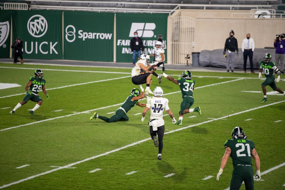 <p>Michigan State University&#x27;s Antjuan Simmons making a tackle midair against Northwestern on Saturday, November 28, 2020.</p>