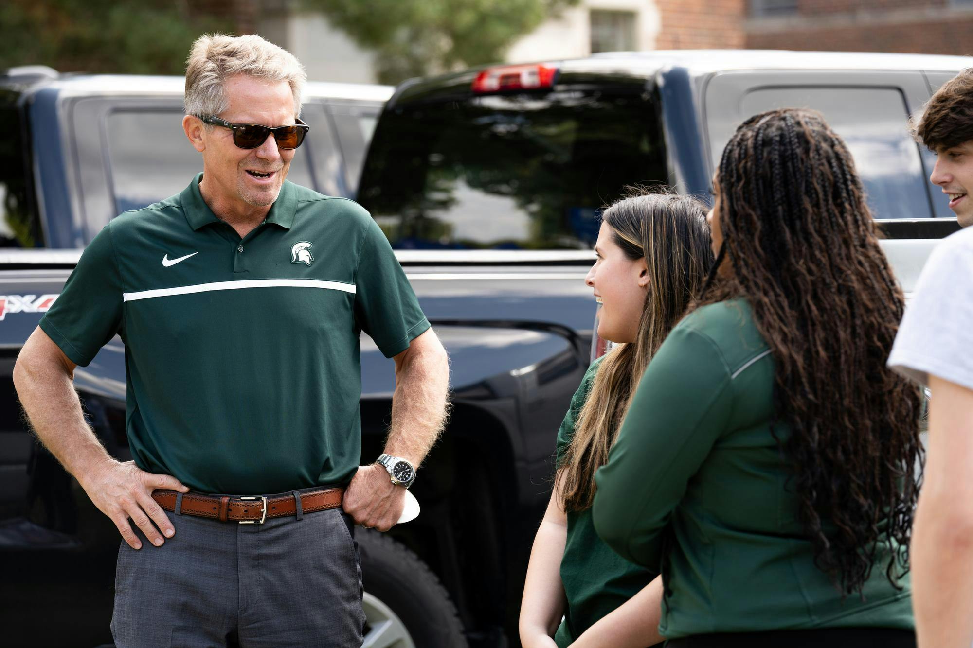 Michigan State University President Kevin Guskiewicz, left, chats with MSU students outside of Snyder Hall, Aug. 21, 2024.