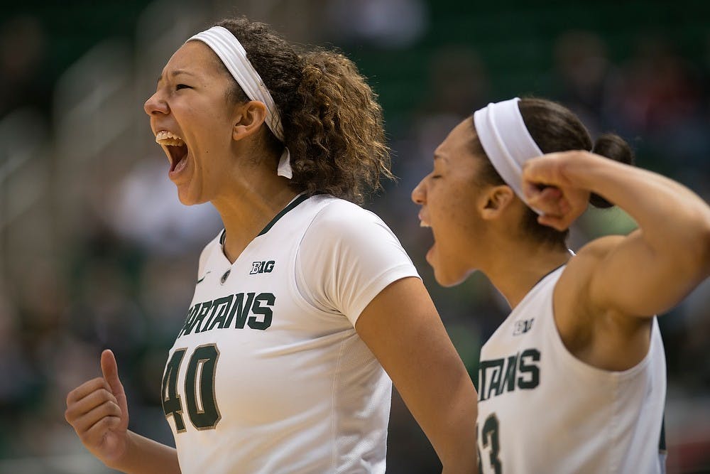 	<p>Junior center Madison Williams, left, and redshirt freshman guard Aerial Powers cheer after a Spartan point Feb. 24, 2014, during the game against Minnesota at Breslin Center. The Spartans defeated the Gophers, 75-61. Julia Nagy/The State News</p>