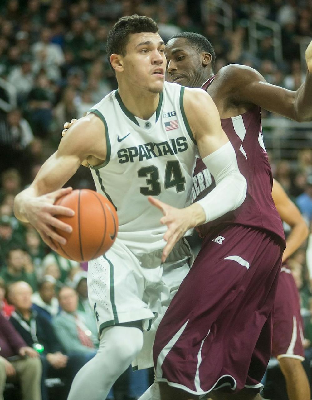 <p>Sophomore forward Gavin Schilling attempts to pass the ball past Texas Southern forward Nick Shepherd Dec. 20, 2014, during the game at Breslin Center. The Spartans were defeated by the Tigers, 71-64. Erin Hampton/The State News</p>