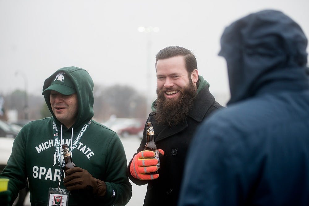 <p>New York City resident Martin Finn, left, and Indianapolis, Indiana resident Andrew Schubeck tailgate with their friends Jan. 1, 2015, before The Cotton Bowl Classic football game against Baylor at AT&T Stadium in Arlington, Texas. It was 34 degrees in Dallas with showers.</p>