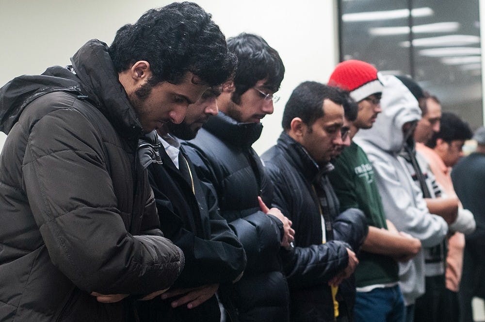 <p>Finance freshman Mohammed Alnuaimi bows in prayer Feb. 21, 2014 at the Islamic Center, 940 S Harrison Rd. The Islamic faith requires followers to pray five times a day. Erin Hampton/The State News</p>