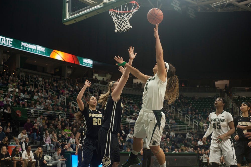 Graduate student center Jasmine Hines shoots a basket while Purdue center Nora Kiesler blocks during the second half of the game against Purdue on Jan. 27, 2016 at Breslin Center. The Spartans defeated