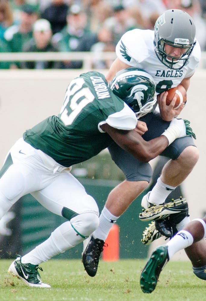 Redshirt freshman defensive end Shilique Calhoun takes down Eastern Michigan quarterback Alex Gillett. MSU defeated Eastern Michigan 23-7 on Saturday, Sept. 22, 2012, at Spartan Stadium. Justin Wan/The State News