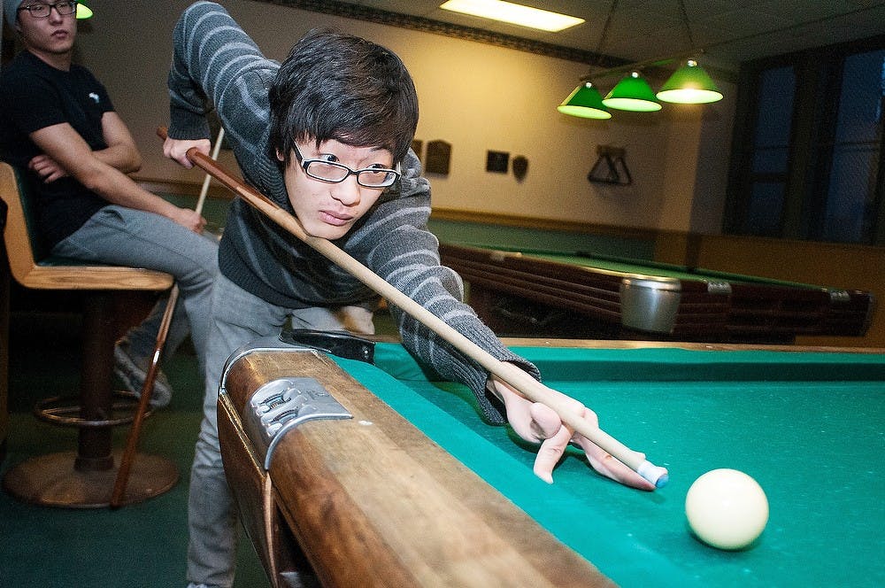 	<p>Mechanical engineering freshman Siyu Chen plays pool on Friday, Feb. 1, 2013, in the billiards room at the Union.  The last day the billiards room will be open is the Friday before spring break until it is closed permanently. Katie Stiefel/The State News</p>
