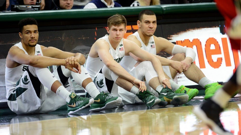 From left to right, redshirt freshman forward Kenny Goins, freshman guard Matt McQuaid, and junior forward Gavin Schilling watch a play during the first half of the game against Rutgers on Jan. 31, 2016 at Breslin Center. The Spartans defeated the Scarlet Knights, 96-62. 