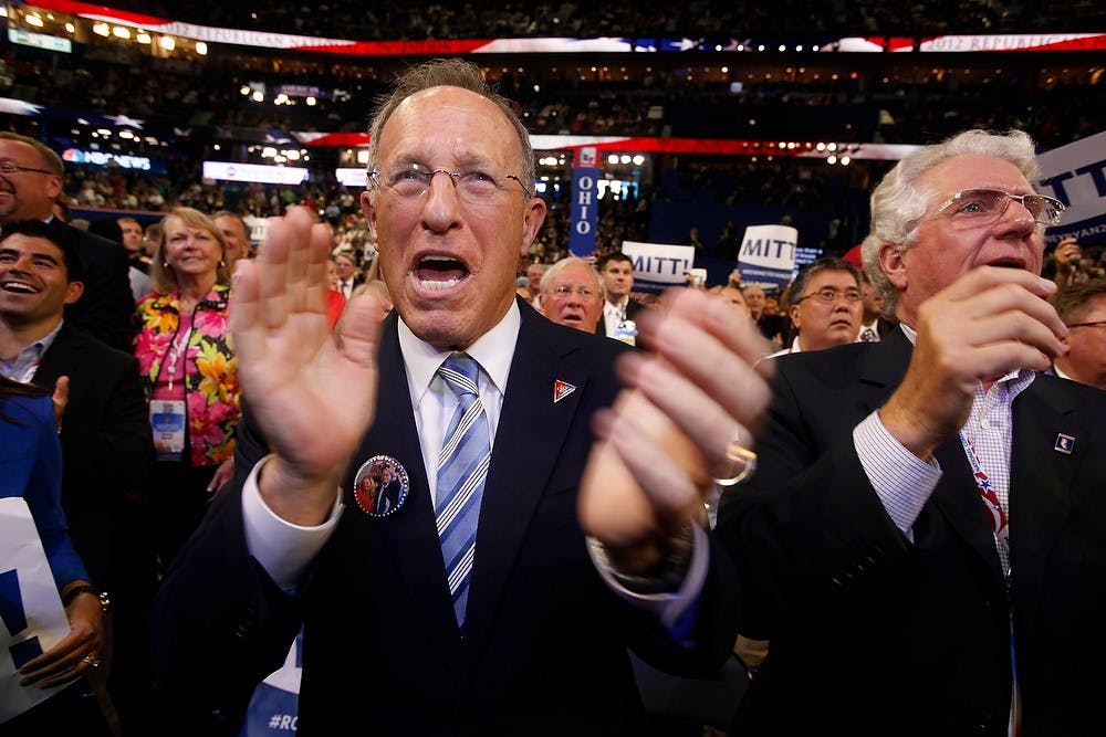 Scott Romney, with the Michigan delegation, cheers for his brother, Mitt, after his brother receives the needed votes for nomination Aug. 28, 2012, at the 2012 Republican National Convention at the Tampa Bay Times Forum in Tampa, Fla. Mark Boster/Los Angeles Times/MCT