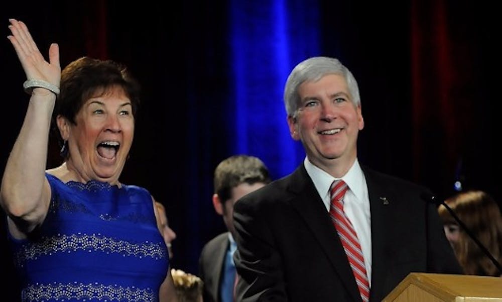 <p>Governor Rick Snyder and wife Sue Snyder celebrate the election win Nov. 4, 2014, at the Detroit Marriott at the Renaissance Center in Detroit, Mich. Jessalyn Tamez/The State News</p>