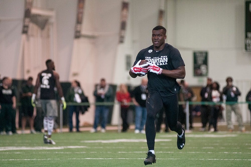 <p>Former MSU football wide receiver Keith Mumphery runs with the ball after catching a pass March 18, 2015 during his Pro Day at the Duffy Daugherty Building. Mumphery was expelled from MSU in 2016 and has been banned from campus until Dec. 31. 2018.</p>