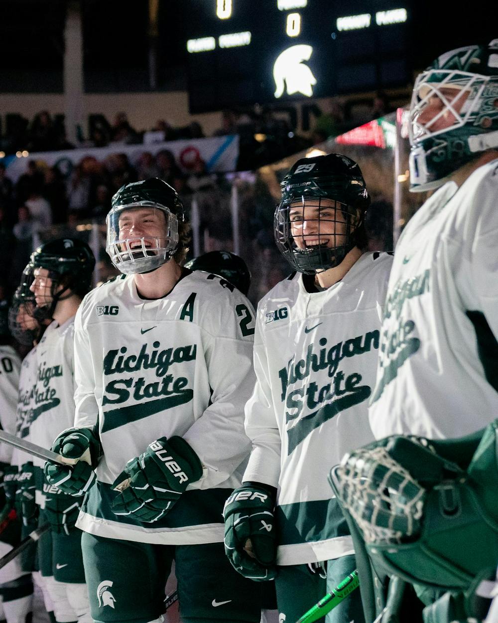 <p>Sophomore forward Karsen Dorwart (28) and freshman forward Gavin O'Connell (29) laughing together before a game against Ohio State University at Munn Ice Arena on March 16, 2024.</p>