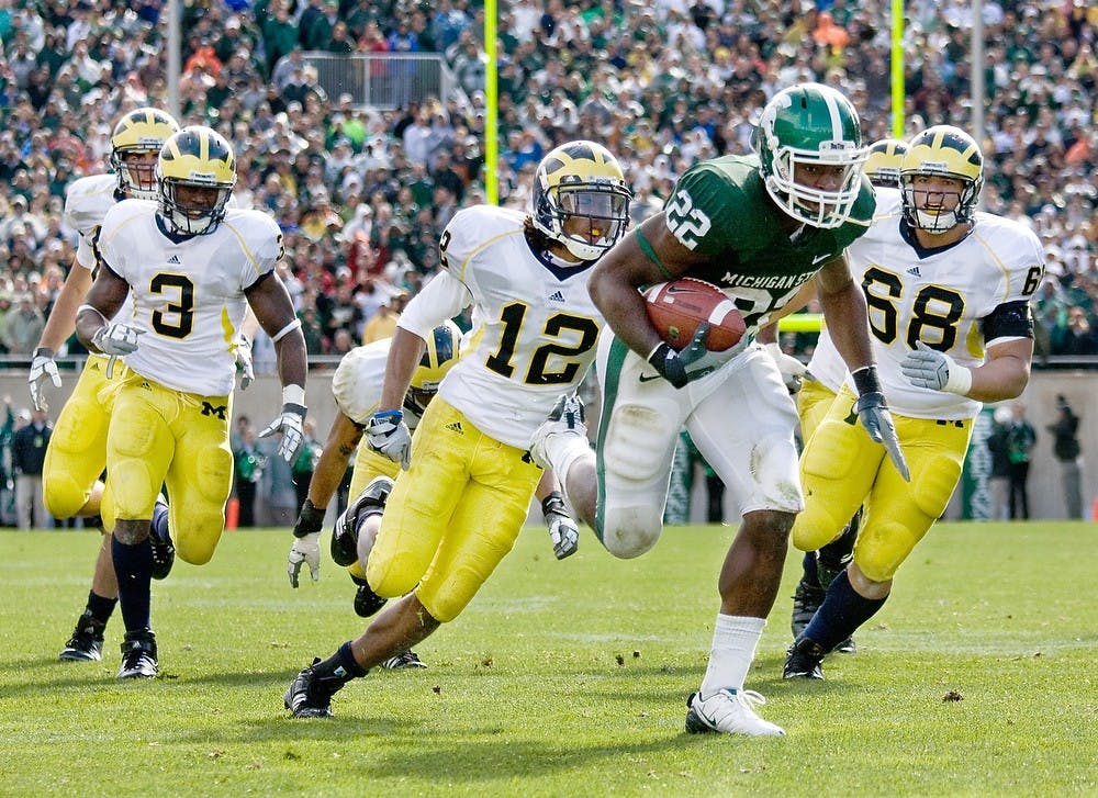 	<p>Then-freshman running back Larry Caper rushes for a Spartan overtime victory, 26-20.</p>