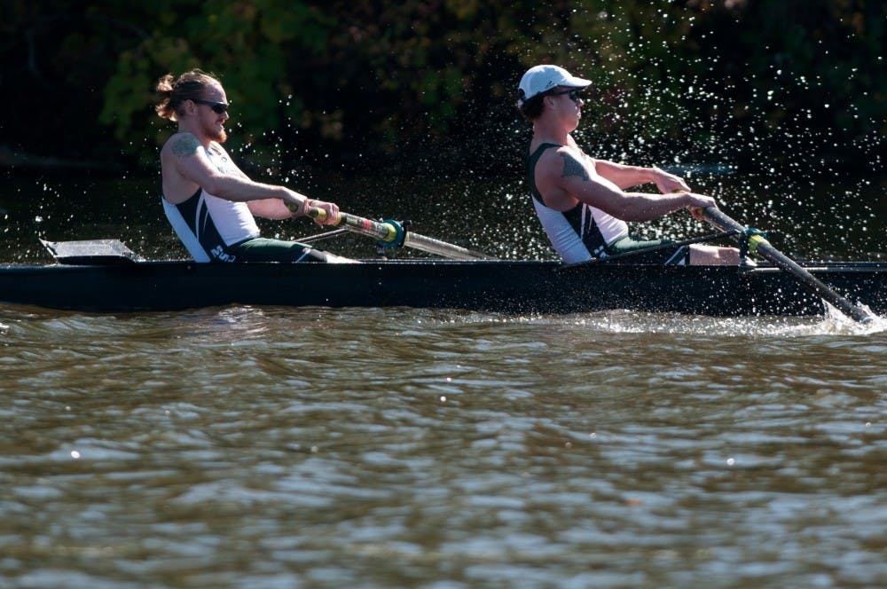 <p>Michael Okeffe, left, and Ryan Crane, right, compete on Oct. 11, 2015, at Grand River Park in Lansing, Mich. The Michigan State University Rowing team hosted their third annual Head of the Grand Regatta.</p>