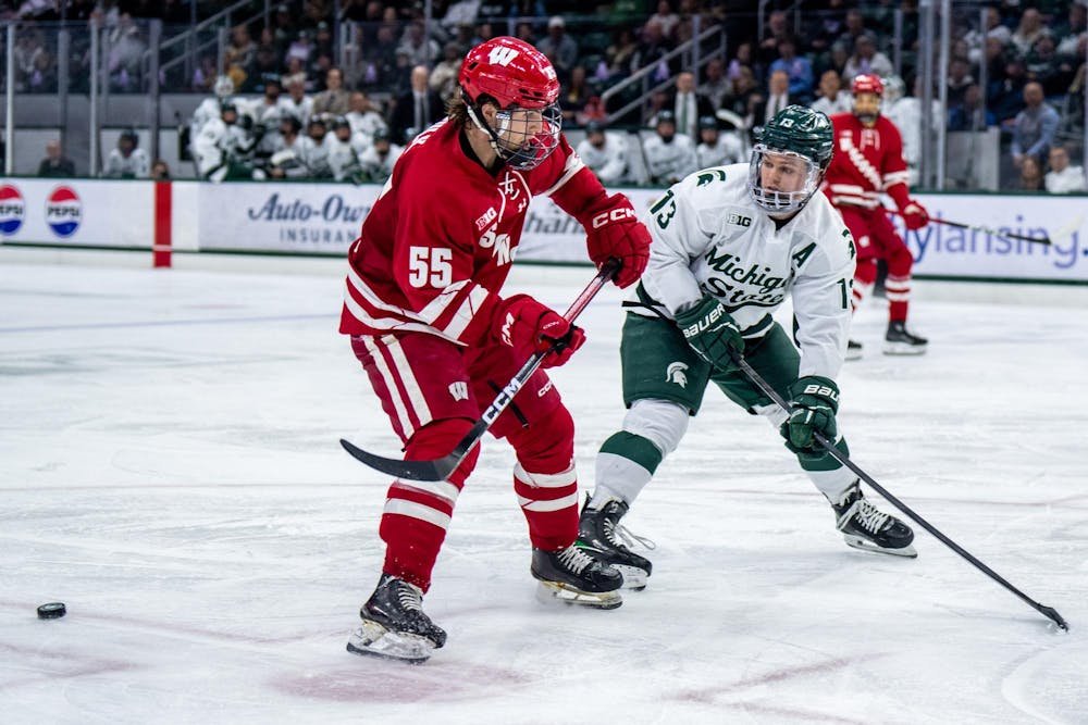<p>Forward Tiernan Shoudy (13) of Michigan State University locks eyes with the puck during a game against Wisconsin at Munn Ice Arena in East Lansing, Mich., on Saturday, Nov. 22, 2025.</p>