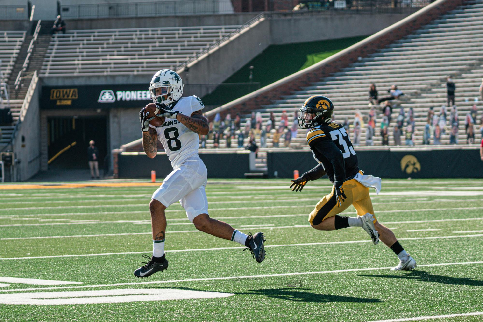 <p>Michigan State receiver Jalen Nailor catches a pass while being guarded by Iowa defensive back Riley Moss on Nov. 7, 2020, at Kinnick Stadium in Iowa City, Iowa. The Spartans lost 49-7 in their first meeting with Iowa since 2017. Photo Courtesy of MSU Athletic Communications.</p>