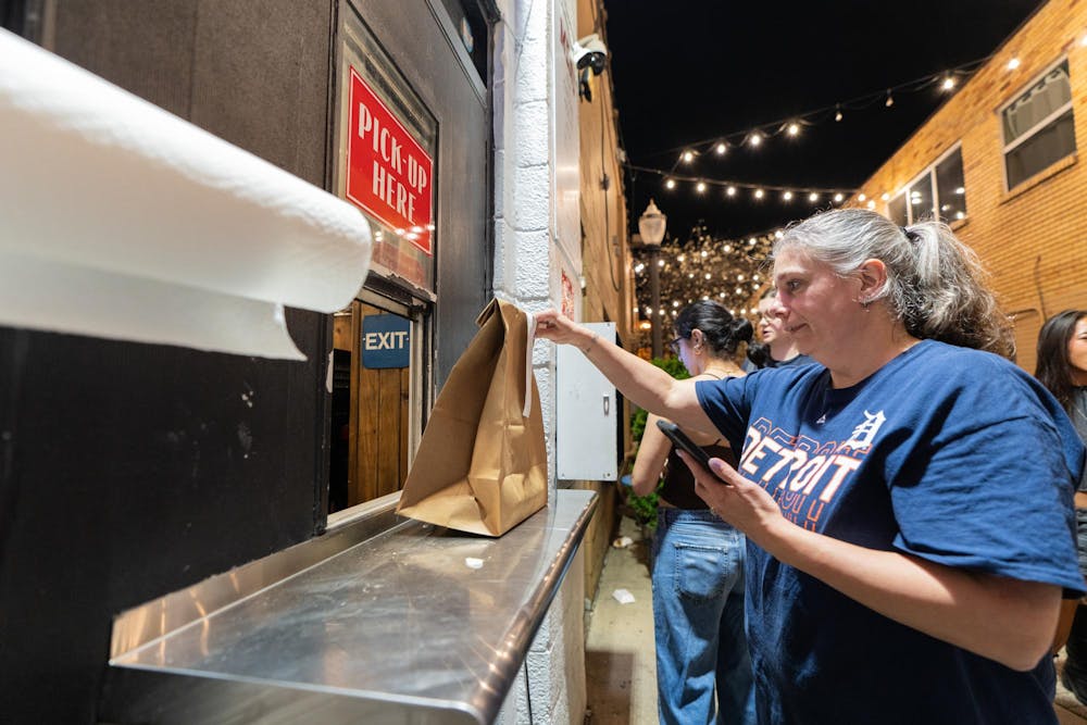 <p>A doordash driver picks up a food delivery from University Weiner in East Lansing, MI on April 17, 2026.</p>