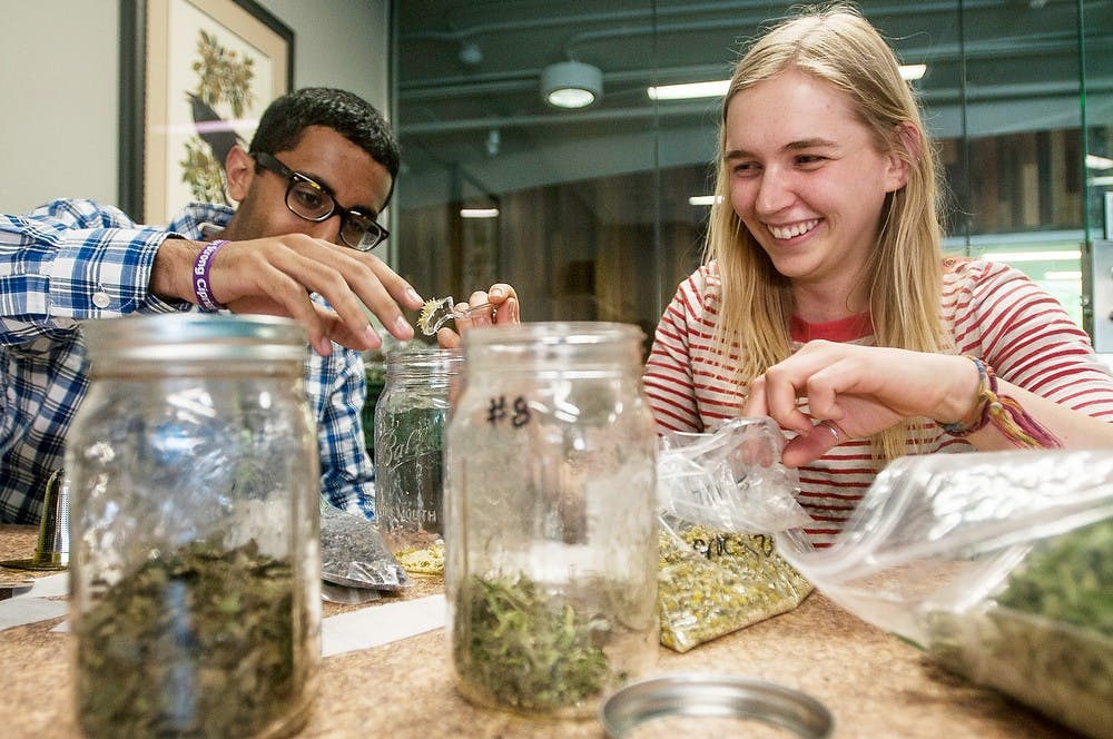 <p>Chemical engineering freshman Abdullah Mohammed and horticulture senior Karri Tomich-Baylis blend tea leaves April 23, 2014, in Bailey Hall. The tea leaves were organically grown in Bailey GREENhouse by MSU's Residential Initiative for the Study of the Environment, commonly known as RISE. Erin Hampton/The State News</p>