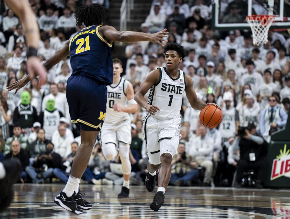 MSU redshirt sophomore guard Jeremy Fears Jr. (1) keeps the ball aways from UM sophomore forward Morez Johnson Jr. (21) at the Breslin Student Events Center on Jan. 30, 2026. 