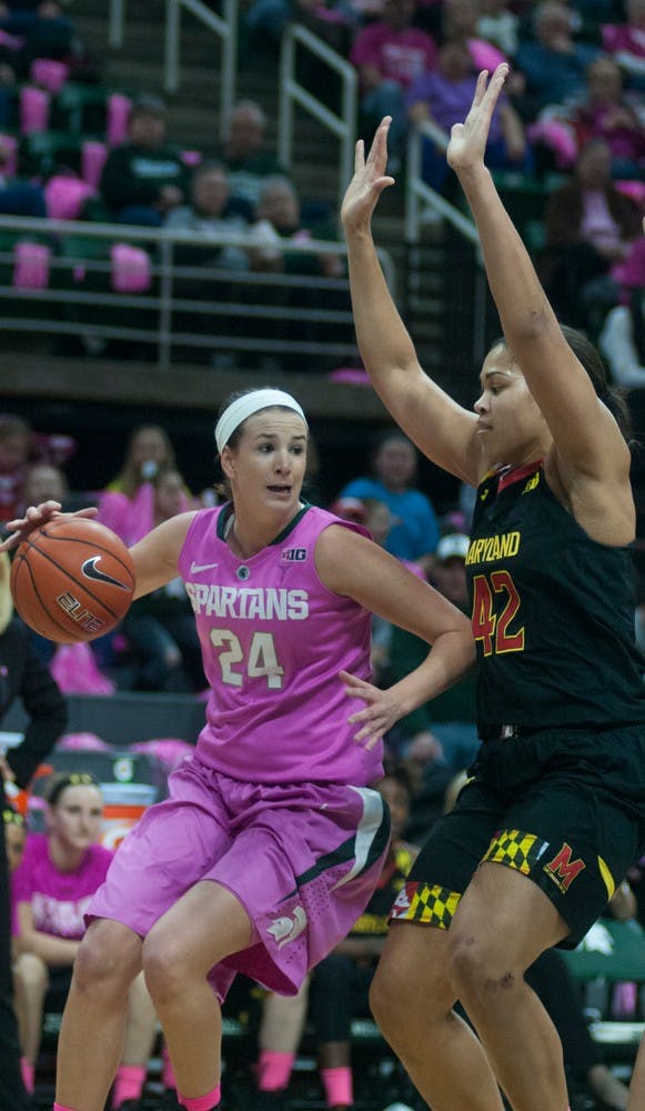 <p>Freshmen guard/forward Lexi Gussert gets around Maryland center Brionna Jones Feb. 16, 2015, during the Play4Kay Breast Cancer Awareness game against Maryland at Breslin Center. The Spartans were defeated by the Terrapins, 75-69. Hannah Levy/The State News</p>