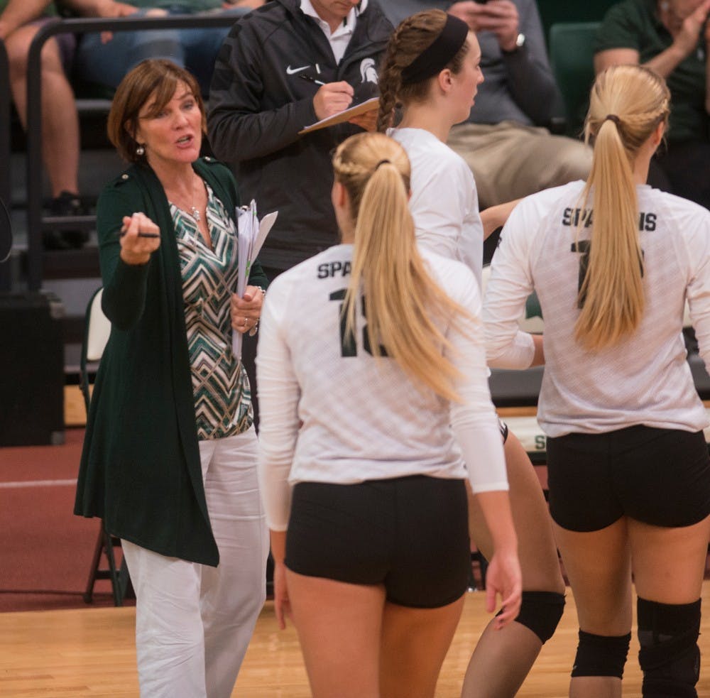 <p>MSU volleyball head coach Cathy George speaks with sophomore outside hitter Holly Toliver during the game against Indiana on Sept. 25, 2015 at Jenison Field House. The Spartans defeated the Hoosiers 3-0.&nbsp;</p>