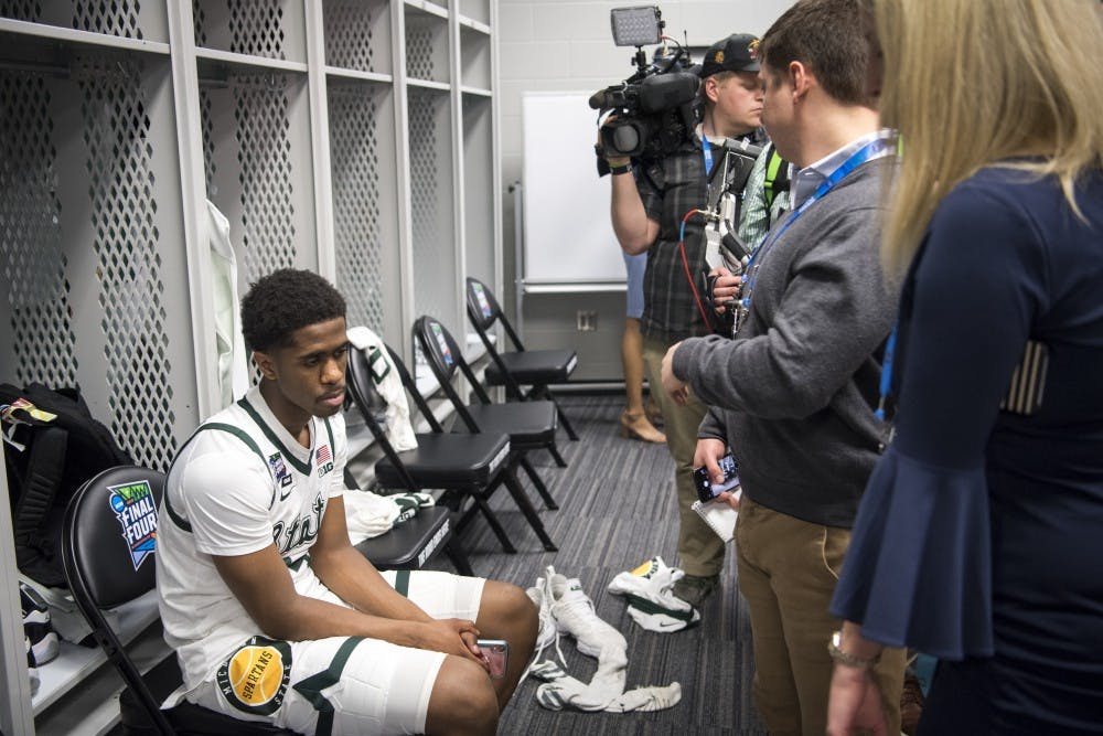 Freshman guard Brock Washington (14) looks on during post-game interviews of the NCAA Final Four game against Texas Tech at U.S. Bank Stadium in Minneapolis on April 6, 2019. The Spartans lost to the Red Raiders 61-51.  (Nic Antaya/The State News)