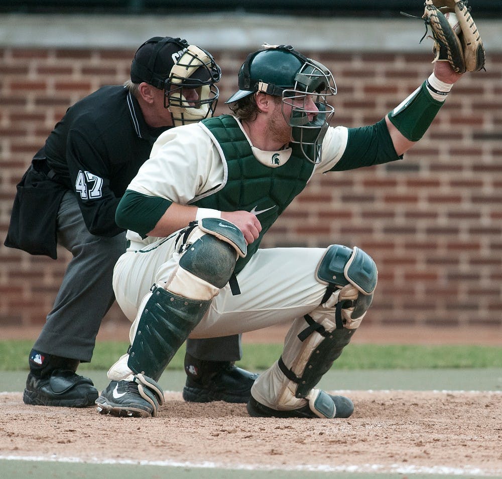 <p>Senior catcher Joel Fisher catches the ball during the game against Purdue on April 12, 2014, at McLane Baseball Stadium at Old College Field. The Spartans defeated the Boilermakers, 2-1. Danyelle Morrow/The State News</p>