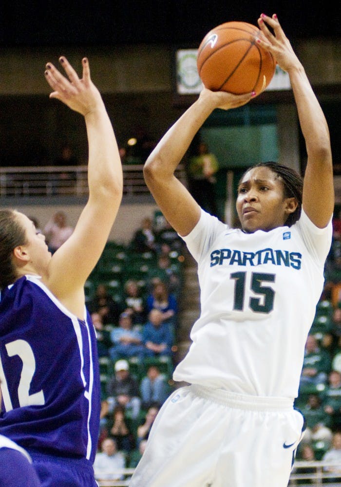 Senior forward Cetera Washington shoots over Northwestern guard Allison Mocchi Thursday at the Breslin Center. The Spartans trail the Wildcats 36-33 at halftime. Matt Radick/The State News