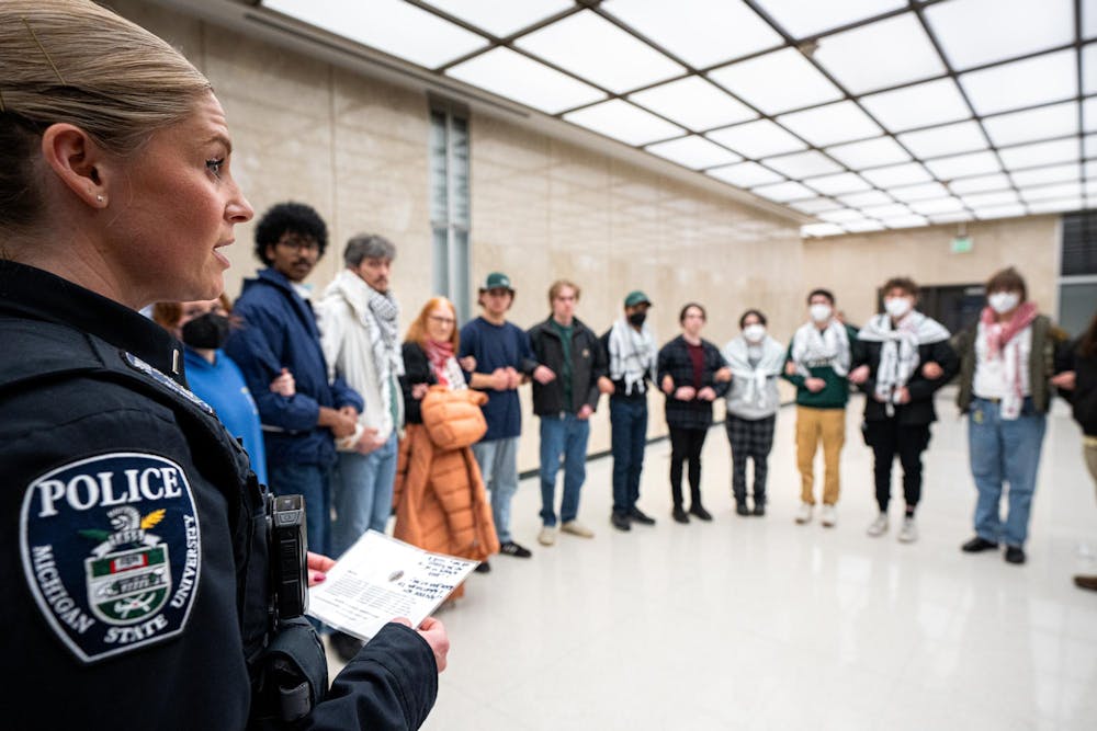 <p>Michigan State University Police Lieutenant Kimberly Parviainen gives the third and final trespassing warning to the Hurriya Coalition and MSU Sunrise at the Hannah Administration Building in East Lansing, Michigan on April 11, 2025. 19 protestors were arrested after multiple warnings from the police.</p>
