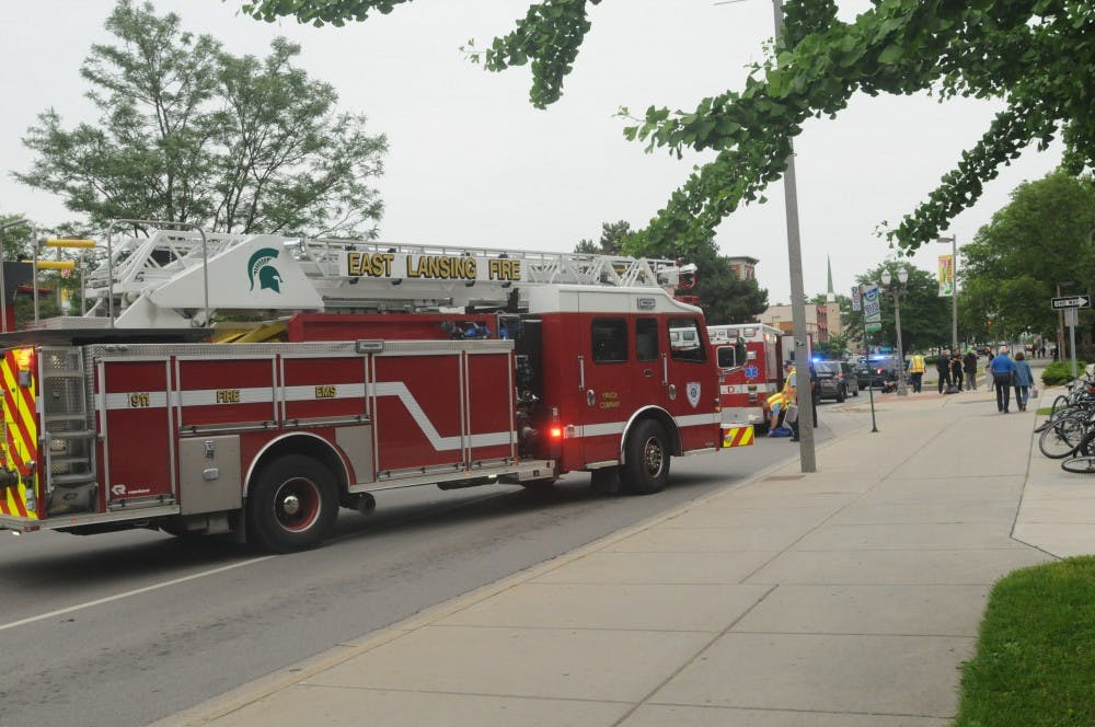 <p>The police and ambulances arrive on the scene where a motorcyclist lost control and crashed into a mini-van on Grand River Ave. near Bubble Island on June 26, 2015. According to East Lansing police Sgt. Chad Pride there were no major injuries. Joshua Abraham/The State News</p>