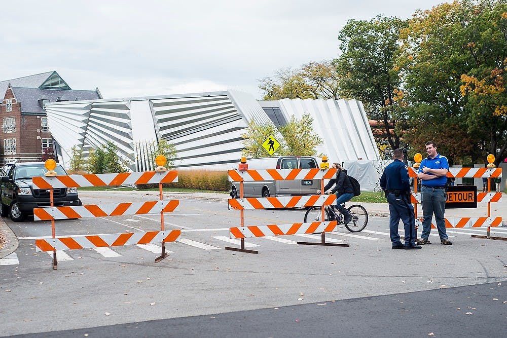 <p>MSU Police block off East Circle Drive Oct. 14, 2014, for the construction and setting up of the Batman vs. Superman: Dawn of Justice movie to be filmed at the Eli and Edythe Broad Art Museum. CATA buses had to be rerouted to work around the block off. Erin Hampton/The State News</p>