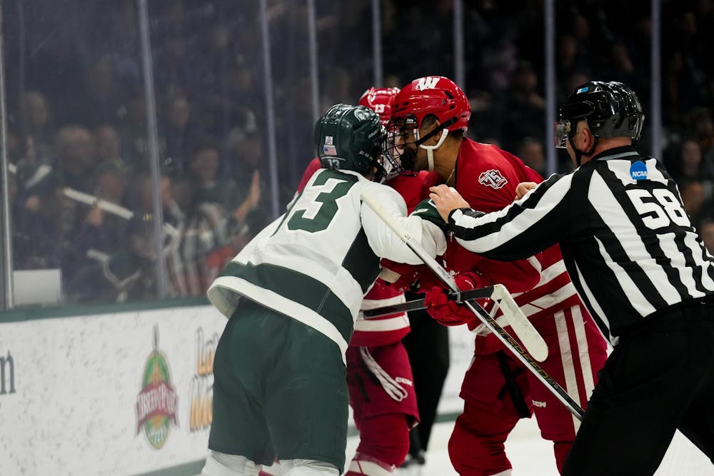 <p>Michigan State left wing Tiernan Shoudy finds himself in a scrum against the Wisconsin Badgers at Munn Ice Arena on Nov. 17, 2023.</p>