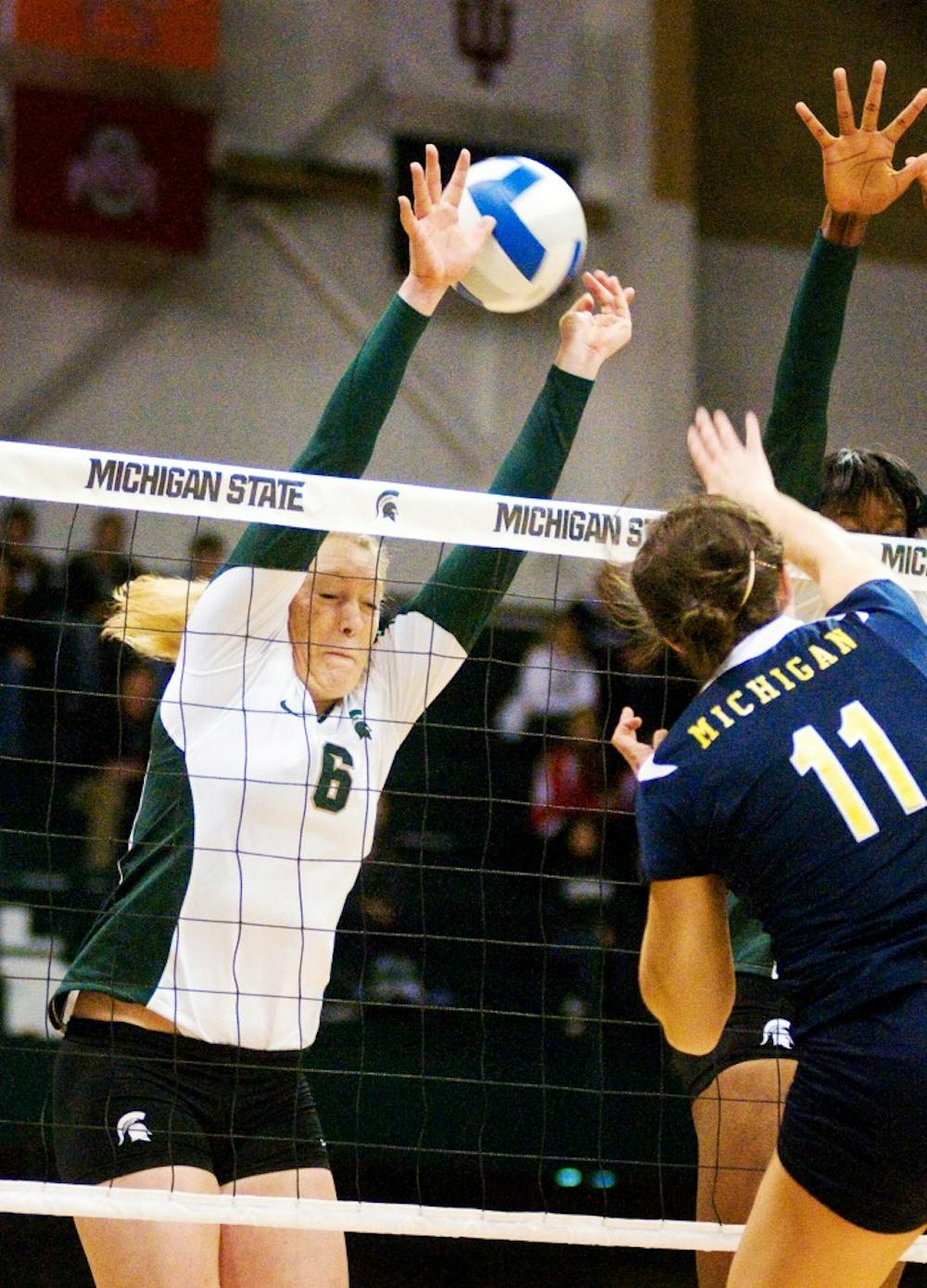 Junior outside hitter Amy Dentlinger blocks a ball Wednesday at Jenison Field House. The Spartans defeated the Michigan Wolverines 3-1. Matt Radick/The State News