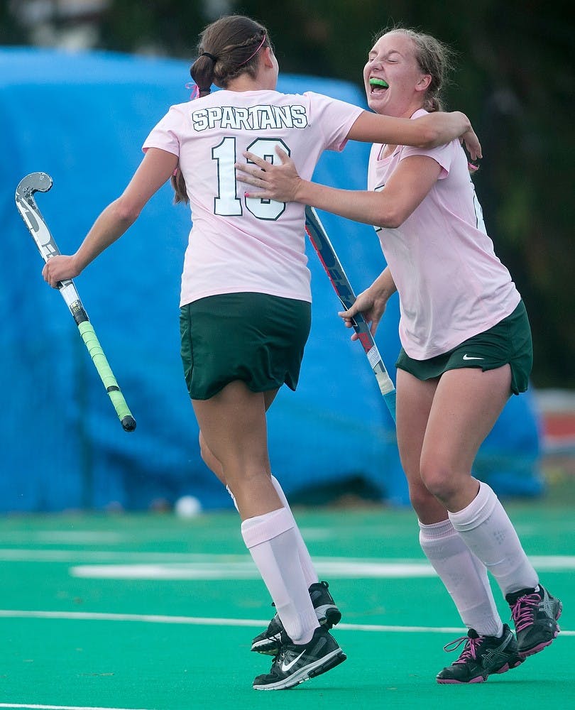 <p>Senior back Michelle Graham, left, celebrates with sophomore midfielder Kristin Matula after she scored a goal on Oct. 17, 2014, at Ralph Young Field during the game against Iowa. The Spartans defeated the Hawkeyes, 2-0. Aerika Williams/The State News</p>