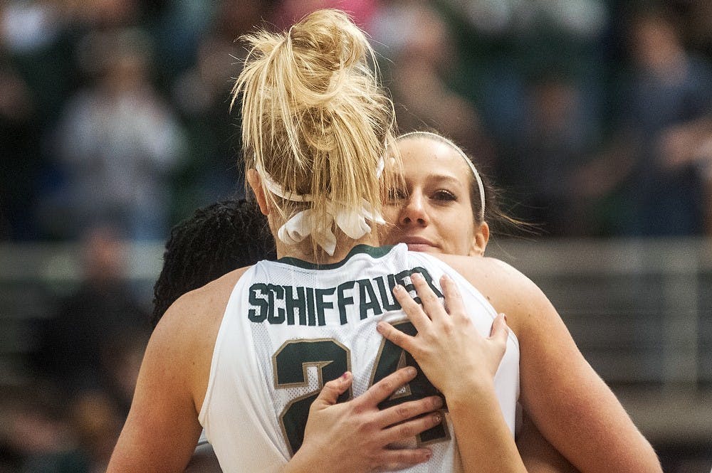 Senior guard Tracy Nogle hugs senior forward Courtney Schiffauer after the game March 3, 2013, at Breslin Center. MSU beat Wisconsin 54-48. Danyelle Morrow/The State News