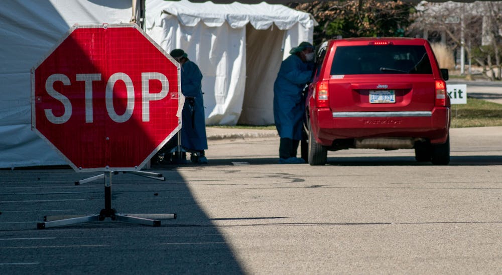 <p>Patients proceed into testing tent at Michigan State University&#x27;s COVID-19 drive-through testing site on April 2, 2020.</p>