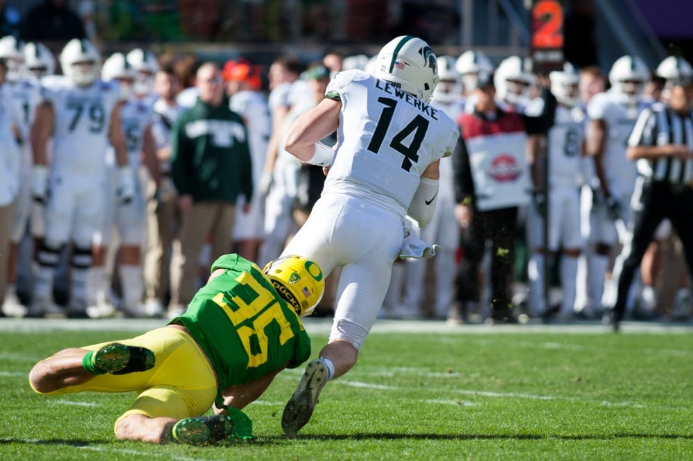 Ducks inside linebacker Troy Dye (35) sacks Spartans QB Brian Lewerke (14). Oregon Ducks Football takes on Michigan State University at Levi’s Stadium in Santa Clara, CA. on Dec. 31, 2018. (Ben Green/Emerald)