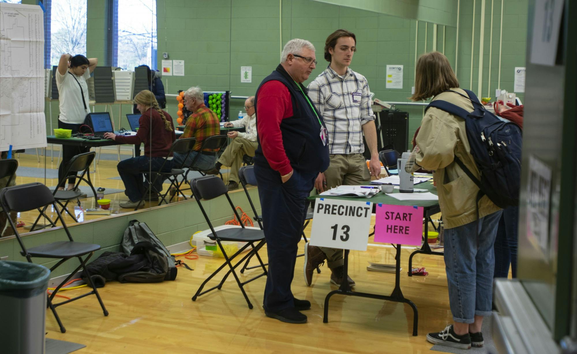 <p>Volunteers help students during their voting process at the District 13 polling precinct in IM Sports East. The Michigan primary day took place March 10, 2020.</p>